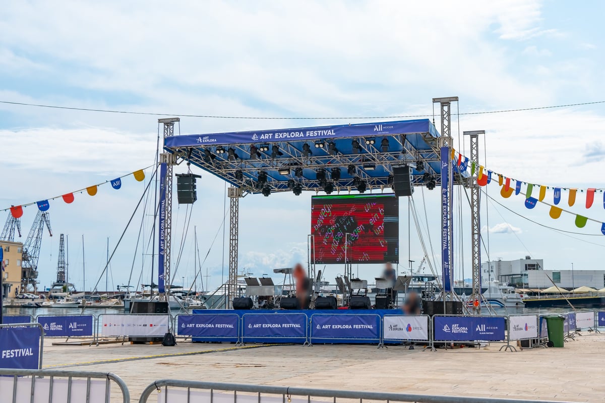 Groot podium met LED schermen, lichten en geluidsapparatuur tijdens een groot festival