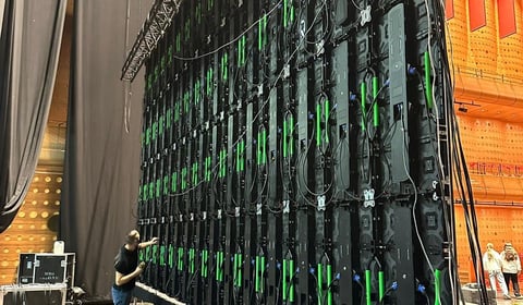Large server rack with black and green hardware panels in a data center